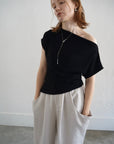 Unbalance tuck top